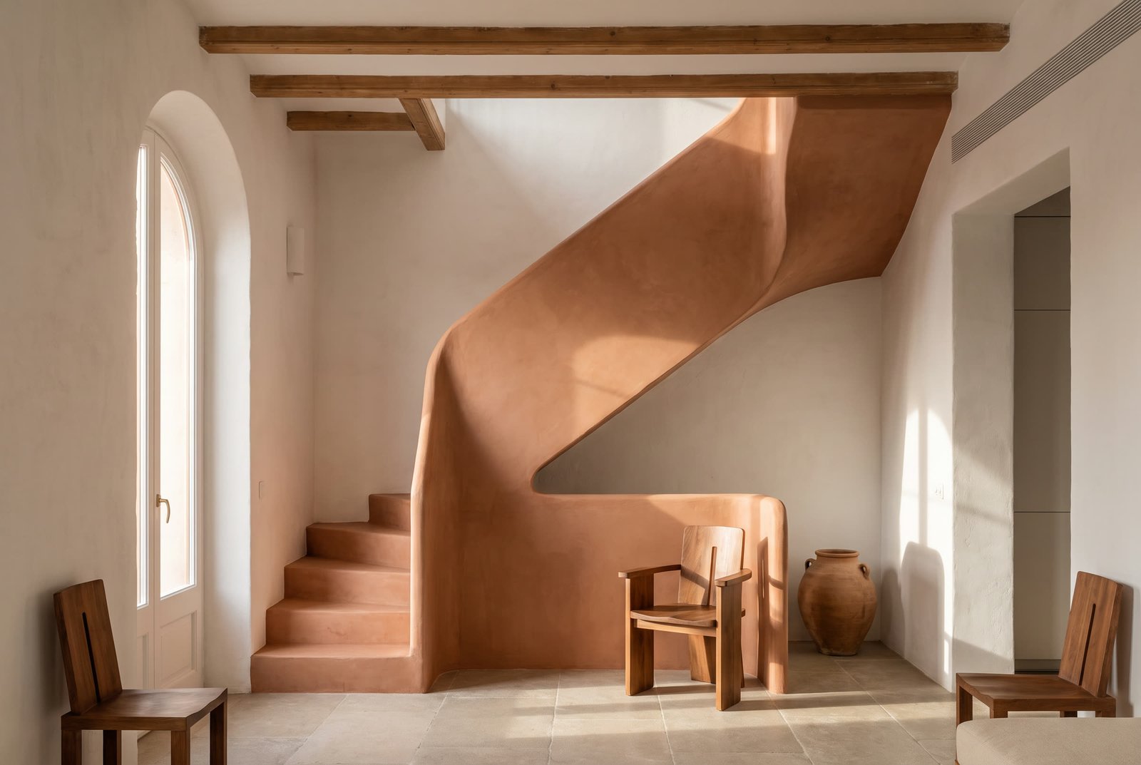 Sculptural terracotta plaster staircase at Terra House.